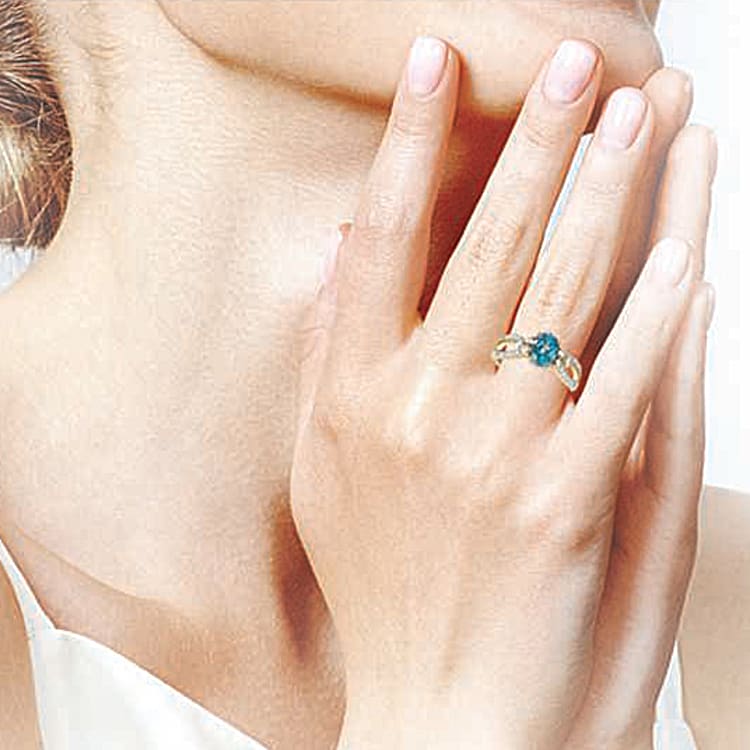 18K Gold Plated Ring Adorned With A Blue Zircon Center Stone And Over 2 Dozen White Zircon Accents