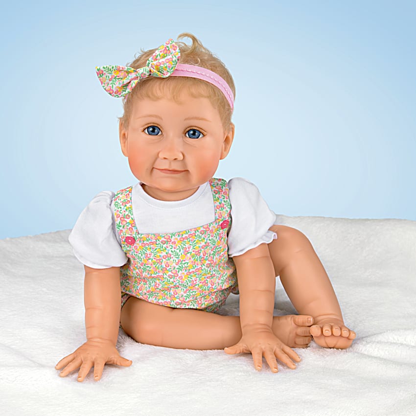 Poseable Lifelike Baby Doll Featuring A Custom Floral-Print Bubble